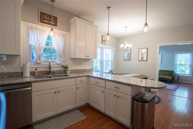 9604 Weston Ln, Henrico, VA 23238 - kitchen with stainless steel dishwasher, a peninsula, backsplash, and a chandelier
