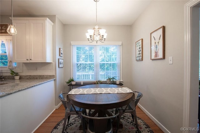 9604 Weston Ln, Henrico, VA 23238 - dining space featuring a chandelier, healthy amount of natural light, dark wood-style flooring, and baseboards