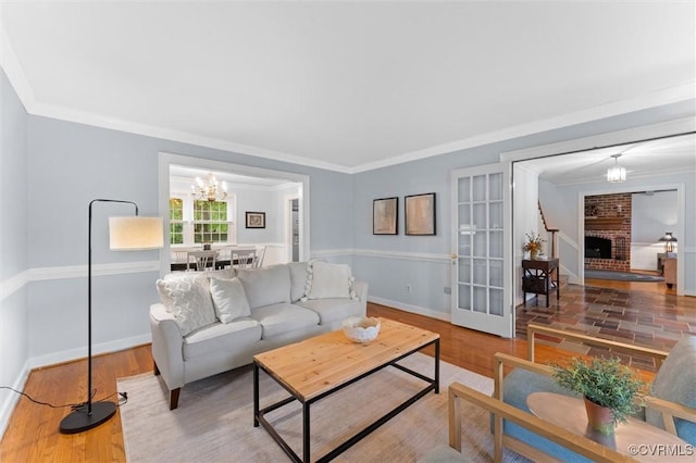9140 Robin Ridge Dr, Hanover, VA 23116 - living room featuring ornamental molding, a chandelier, wood finished floors, baseboards, and french doors
