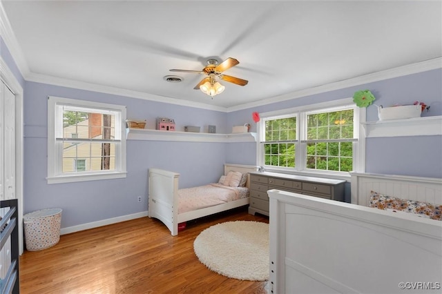 9140 Robin Ridge Dr, Hanover, VA 23116 - bedroom with multiple windows, light wood-style floors, ornamental molding, a closet, and baseboards