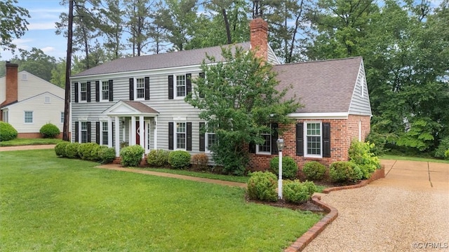 9140 Robin Ridge Dr, Hanover, VA 23116 - colonial-style house with a chimney, a front lawn, a shingled roof, and brick siding