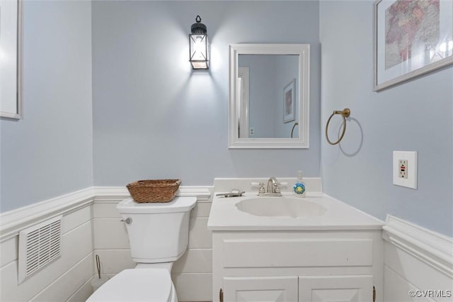 9140 Robin Ridge Dr, Hanover, VA 23116 - half bathroom featuring toilet, vanity, and wainscoting