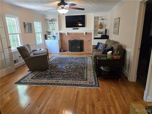 9701 Waterfowl Flyway, Chesterfield, VA 23838 - living room with built in features, wood finished floors, crown molding, a fireplace, and ceiling fan