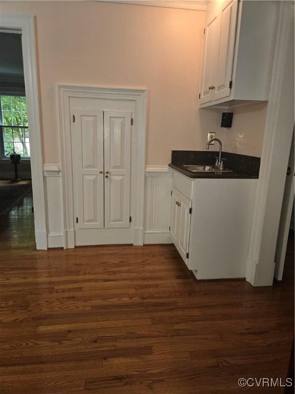 9701 Waterfowl Flyway, Chesterfield, VA 23838 - kitchen with a sink, dark countertops, white cabinets, dark wood-style floors, and wainscoting