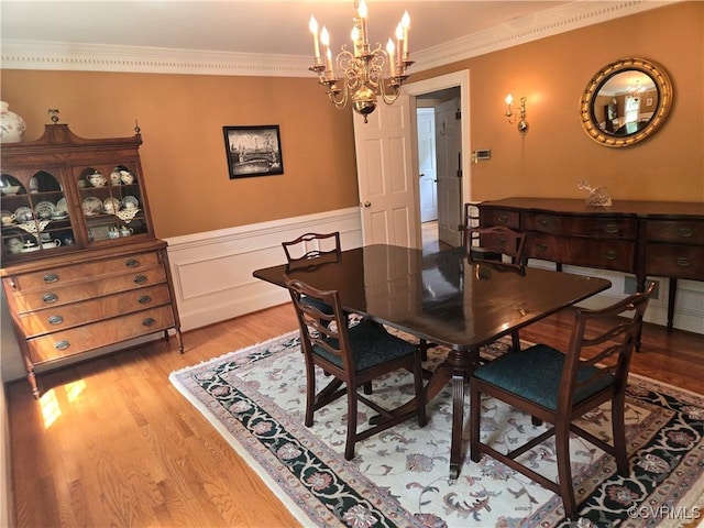 9701 Waterfowl Flyway, Chesterfield, VA 23838 - dining space with a chandelier, light wood-style flooring, crown molding, and a wainscoted wall