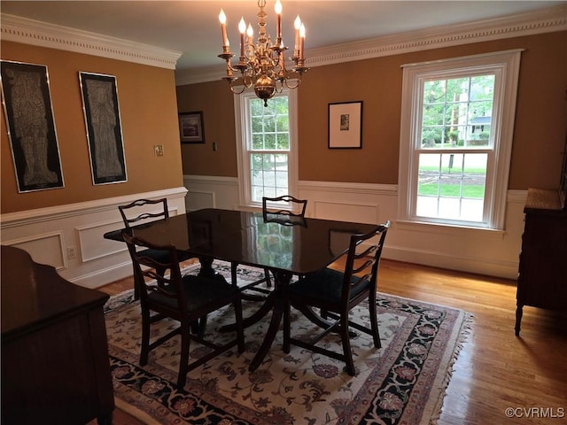 9701 Waterfowl Flyway, Chesterfield, VA 23838 - dining area with healthy amount of natural light, a chandelier, wainscoting, light wood-style flooring, and ornamental molding