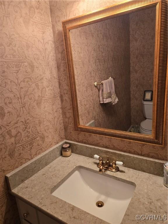 9701 Waterfowl Flyway, Chesterfield, VA 23838 - half bathroom featuring wallpapered walls, toilet, and vanity