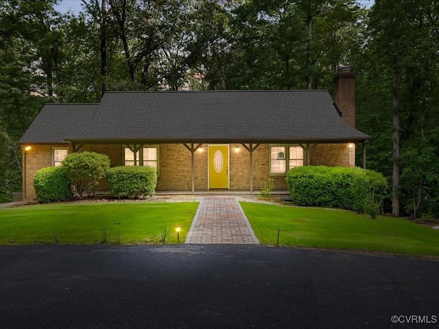 13610 Old Stage Rd, North Prince George, VA 23860 - view of front of house with a chimney, a front lawn, and brick siding