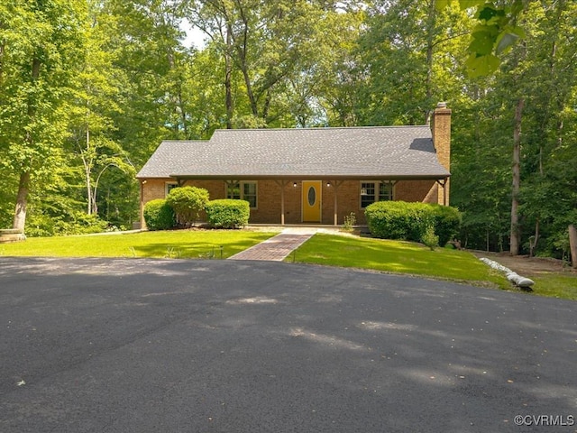 13610 Old Stage Rd, North Prince George, VA 23860 - view of front of house featuring a chimney, driveway, a front yard, and brick siding