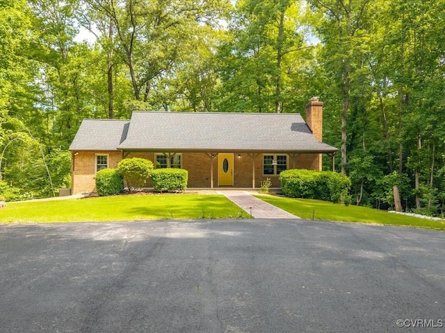 13610 Old Stage Rd, North Prince George, VA 23860 - view of front facade featuring a chimney, a front lawn, and brick siding