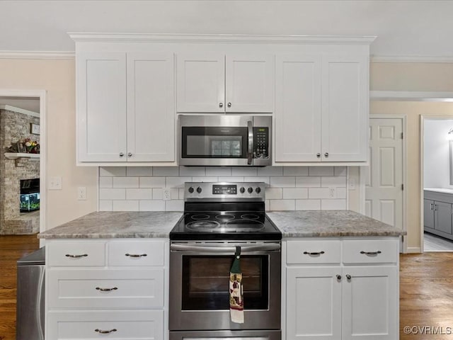 13610 Old Stage Rd, North Prince George, VA 23860 - kitchen with appliances with stainless steel finishes, light wood-type flooring, ornamental molding, tasteful backsplash, and white cabinets