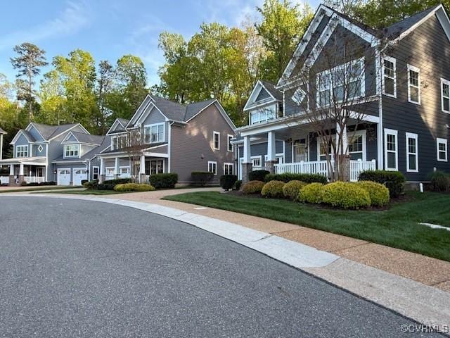 9477 Creek Summit Cir, Richmond, VA 23235 - view of front of property with a porch, a residential view, and a front lawn