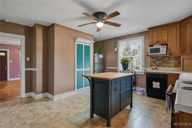 100 N Battery St, Henrico, VA 23075 - kitchen with black dishwasher, white microwave, freestanding refrigerator, range with electric stovetop, and butcher block countertops