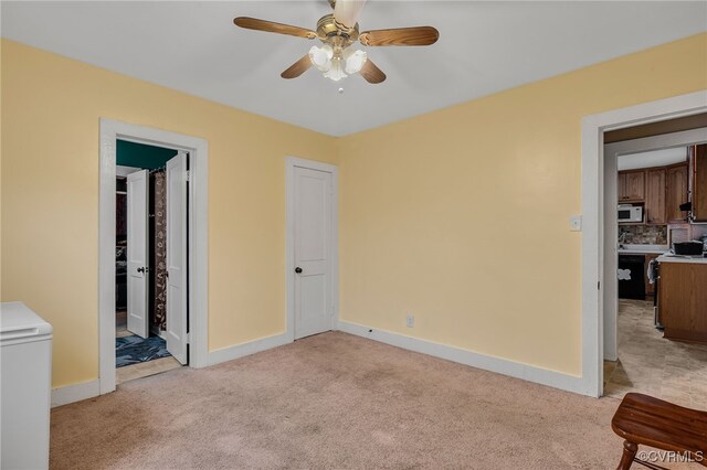 100 N Battery St, Henrico, VA 23075 - unfurnished bedroom featuring light carpet, baseboards, and a ceiling fan