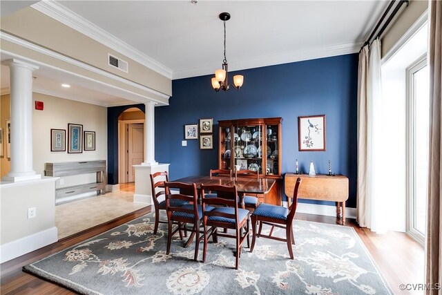 1350 Westwood Ave Unit 406, Richmond, VA 23227 - dining room featuring decorative columns, wood finished floors, crown molding, arched walkways, and a chandelier