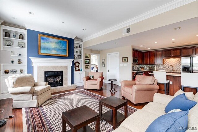1350 Westwood Ave Unit 406, Richmond, VA 23227 - living room with wood finished floors, crown molding, built in shelves, a premium fireplace, and recessed lighting