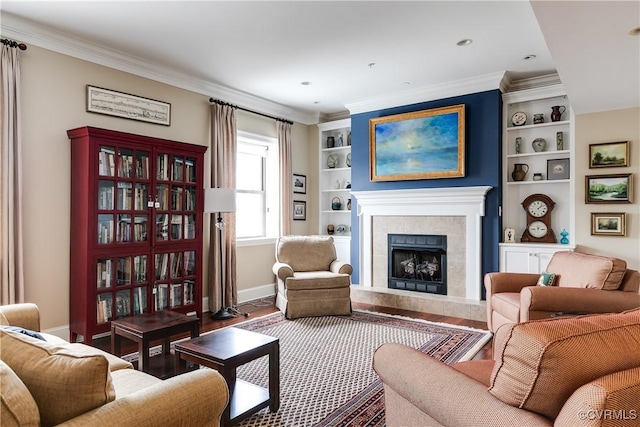 1350 Westwood Ave Unit 406, Richmond, VA 23227 - living room with wood finished floors, baseboards, a fireplace, built in shelves, and crown molding