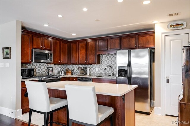 1350 Westwood Ave Unit 406, Richmond, VA 23227 - kitchen featuring appliances with stainless steel finishes, a sink, light countertops, backsplash, and recessed lighting