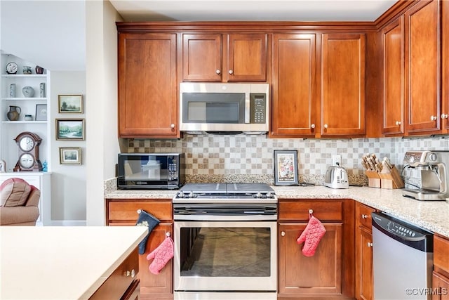 1350 Westwood Ave Unit 406, Richmond, VA 23227 - kitchen featuring stainless steel appliances, decorative backsplash, and brown cabinets