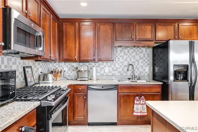 1350 Westwood Ave Unit 406, Richmond, VA 23227 - kitchen featuring stainless steel appliances, a sink, backsplash, light stone counters, and light tile patterned floors