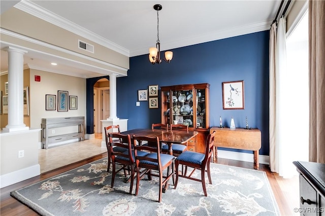 1350 Westwood Ave Unit 406, Richmond, VA 23227 - dining space with decorative columns, wood finished floors, crown molding, arched walkways, and baseboards