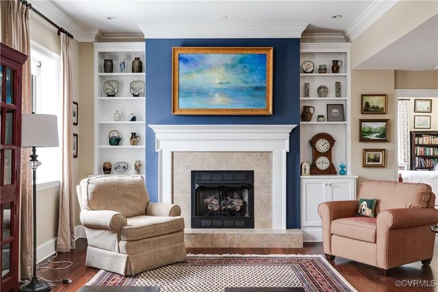 1350 Westwood Ave Unit 406, Richmond, VA 23227 - living area with wood finished floors, ornamental molding, built in shelves, a tiled fireplace, and baseboards