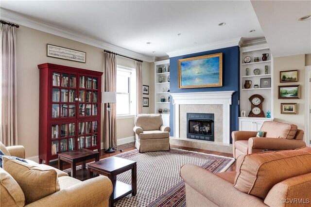 1350 Westwood Ave Unit 406, Richmond, VA 23227 - living area featuring wood finished floors, a tiled fireplace, baseboards, crown molding, and built in shelves