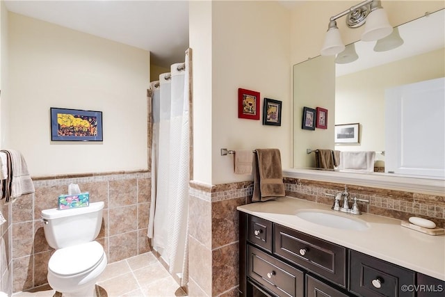 1350 Westwood Ave Unit 406, Richmond, VA 23227 - bathroom with tile walls, vanity, toilet, wainscoting, and tile patterned flooring