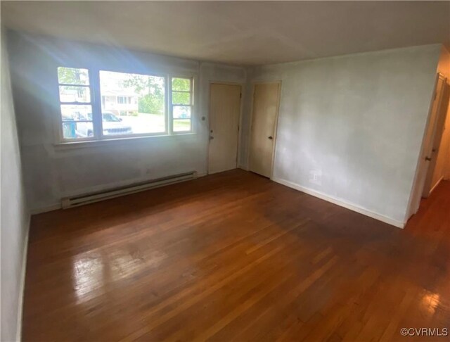205 N Beech Ave, Henrico, VA 23075 - unfurnished room featuring baseboard heating, wood finished floors, and baseboards