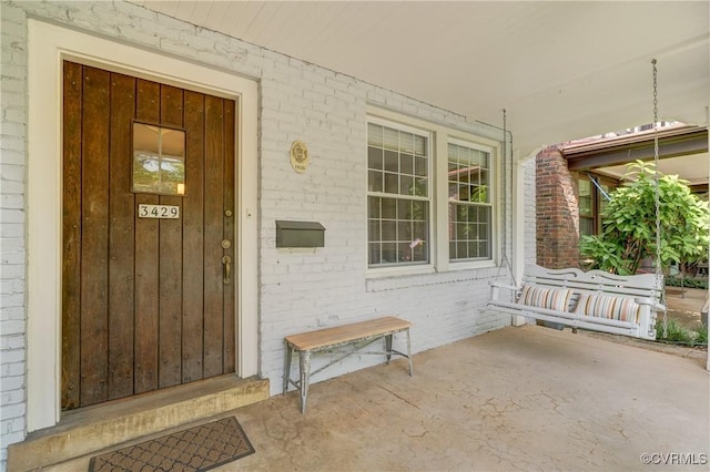 3429 Hanover Ave, Richmond, VA 23221 - view of exterior entry with a porch and brick siding