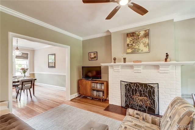 3429 Hanover Ave, Richmond, VA 23221 - living area with crown molding, wood finished floors, a ceiling fan, a fireplace, and baseboards