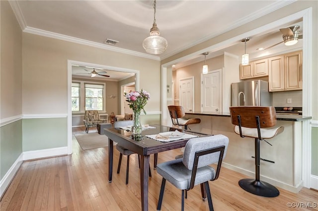 3429 Hanover Ave, Richmond, VA 23221 - dining room featuring light wood-type flooring, baseboards, crown molding, and ceiling fan