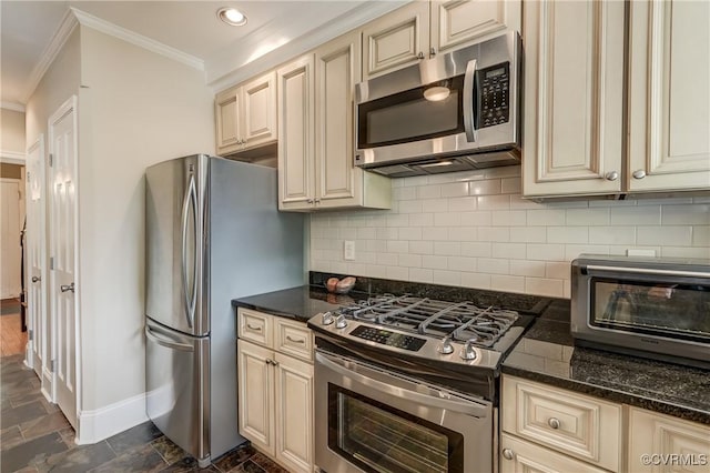 3429 Hanover Ave, Richmond, VA 23221 - kitchen featuring cream cabinetry, stainless steel appliances, ornamental molding, baseboards, and dark stone finish flooring