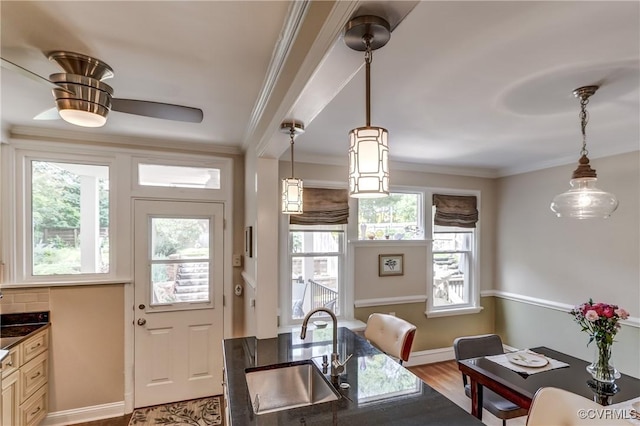 3429 Hanover Ave, Richmond, VA 23221 - dining area featuring crown molding, wood finished floors, a ceiling fan, and baseboards