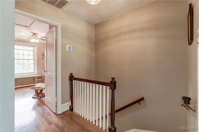 3429 Hanover Ave, Richmond, VA 23221 - stairway featuring wood finished floors, attic access, baseboards, radiator, and ceiling fan