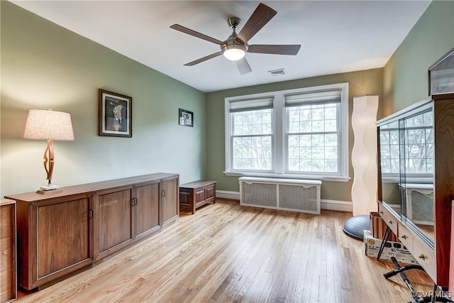 3429 Hanover Ave, Richmond, VA 23221 - home office with radiator heating unit, light wood-style floors, a ceiling fan, and baseboards
