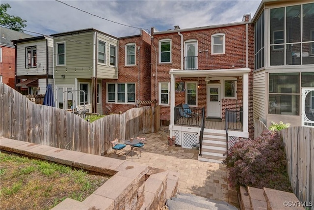 3429 Hanover Ave, Richmond, VA 23221 - rear view of house with brick siding and a fenced backyard