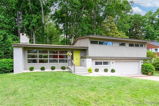 5 Downing Pl, Newport News, VA 23606 - tri-level home with driveway, a garage, a chimney, and a front yard