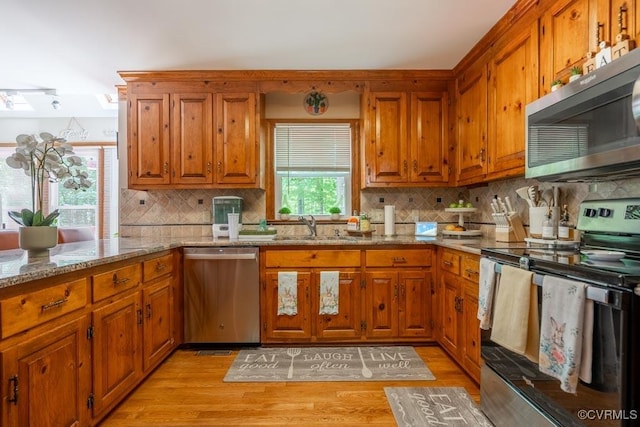 12601 W Patrick Henry Rd, Ashland, VA 23005 - kitchen with stainless steel appliances, a sink, and brown cabinets