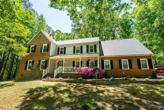 12601 W Patrick Henry Rd, Ashland, VA 23005 - colonial-style house featuring a porch, brick siding, a front yard, and roof with shingles