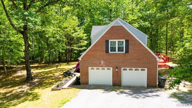 12601 W Patrick Henry Rd, Ashland, VA 23005 - view of side of home with a view of trees, gravel driveway, and brick siding