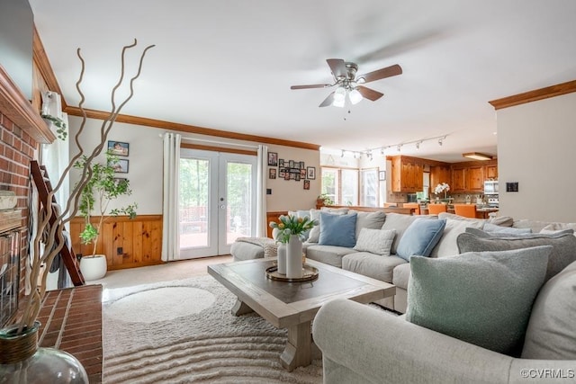 12601 W Patrick Henry Rd, Ashland, VA 23005 - carpeted living area featuring a wainscoted wall, ornamental molding, a ceiling fan, french doors, and wood walls