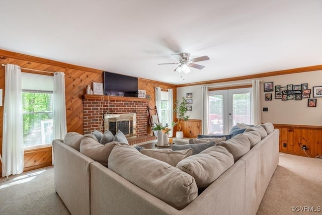 12601 W Patrick Henry Rd, Ashland, VA 23005 - living room with wood walls, healthy amount of natural light, light carpet, ceiling fan, and crown molding
