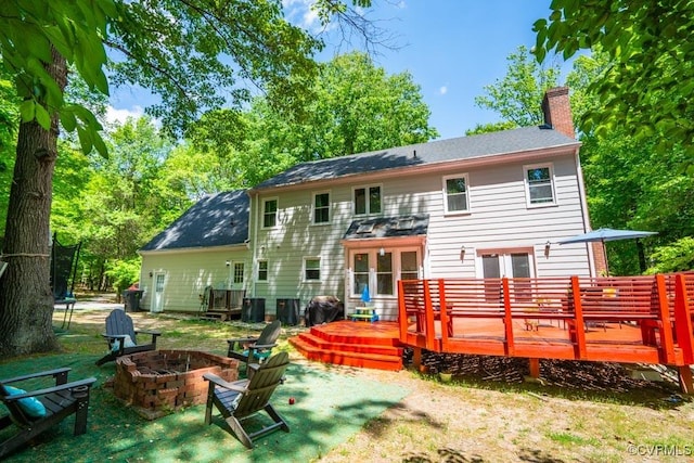 12601 W Patrick Henry Rd, Ashland, VA 23005 - rear view of property featuring a chimney, an outdoor fire pit, and a wooden deck