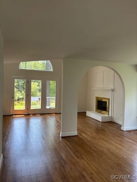 12513 Caitlin Cir, Henrico, VA 23233 - unfurnished living room featuring arched walkways, healthy amount of natural light, and dark wood-style flooring