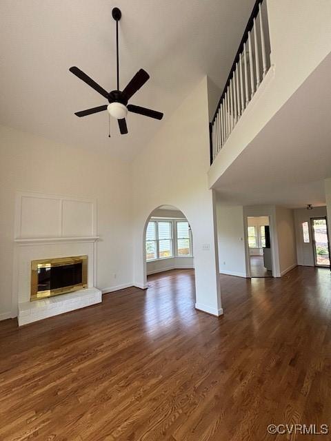 12513 Caitlin Cir, Henrico, VA 23233 - unfurnished living room with a high ceiling, ceiling fan, wood finished floors, and a glass covered fireplace