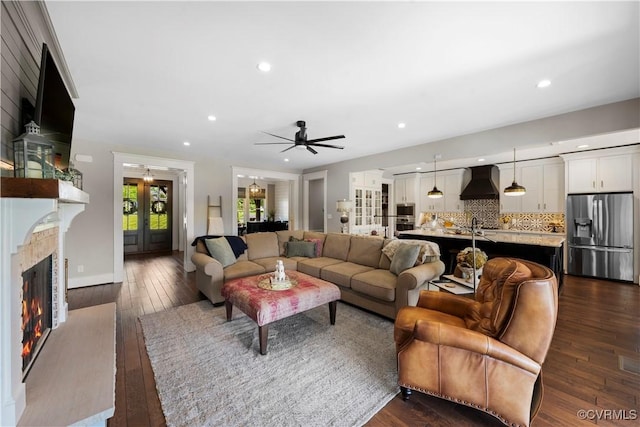 3397 Manor Oaks Dr, Powhatan, VA 23139 - living room with dark wood-style floors, recessed lighting, a lit fireplace, and a ceiling fan