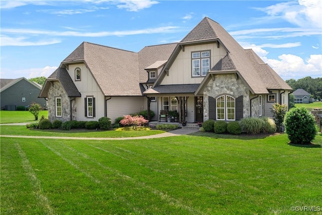 3397 Manor Oaks Dr, Powhatan, VA 23139 - view of front of house with stone siding, a front yard, board and batten siding, and a porch