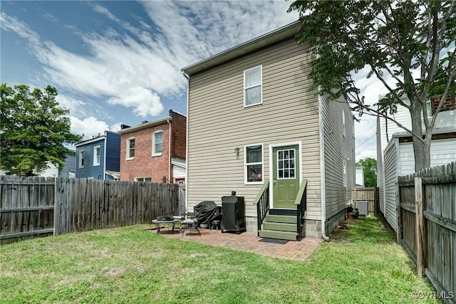 3107 Q St, Richmond, VA 23223 - rear view of house featuring entry steps, a fenced backyard, an outdoor fire pit, and a patio area