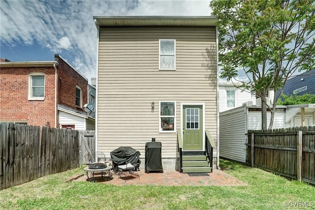3107 Q St, Richmond, VA 23223 - back of house featuring entry steps, a fenced backyard, an outdoor fire pit, and a patio area